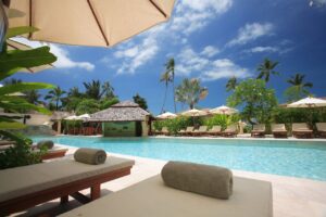 Luxury oceanfront Jacuzzi suite with a panoramic view of the Caribbean at sunset.